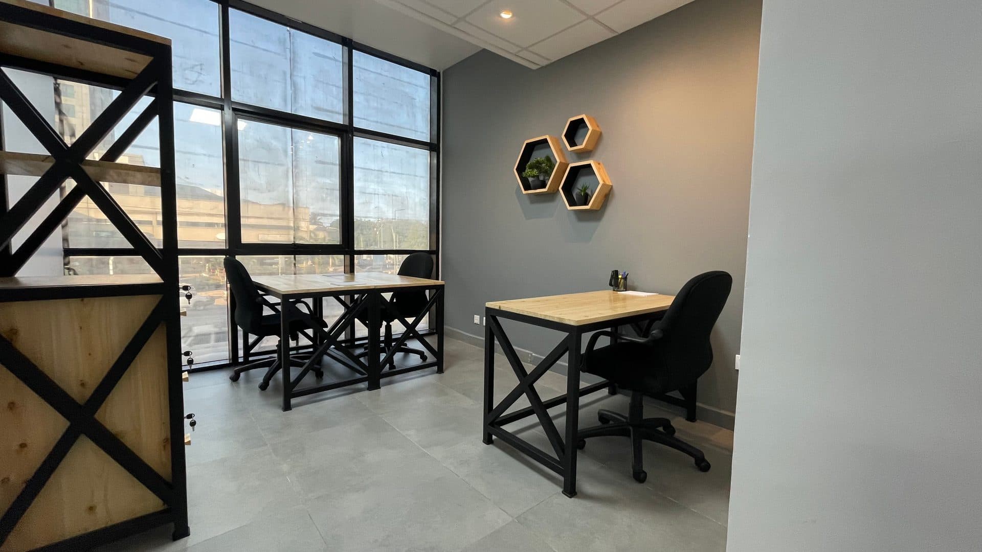 A three-person office at The Hive with large windows